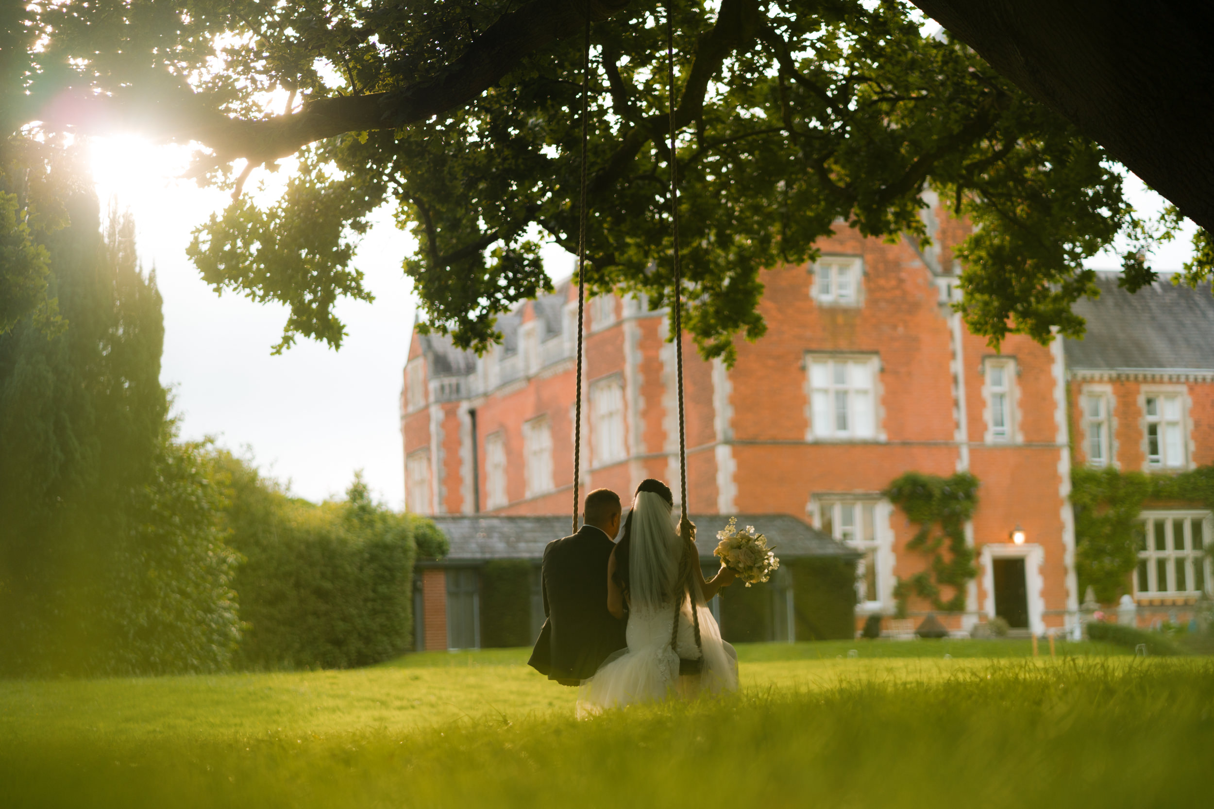 Bride and groom on the swing at Thicket Priory