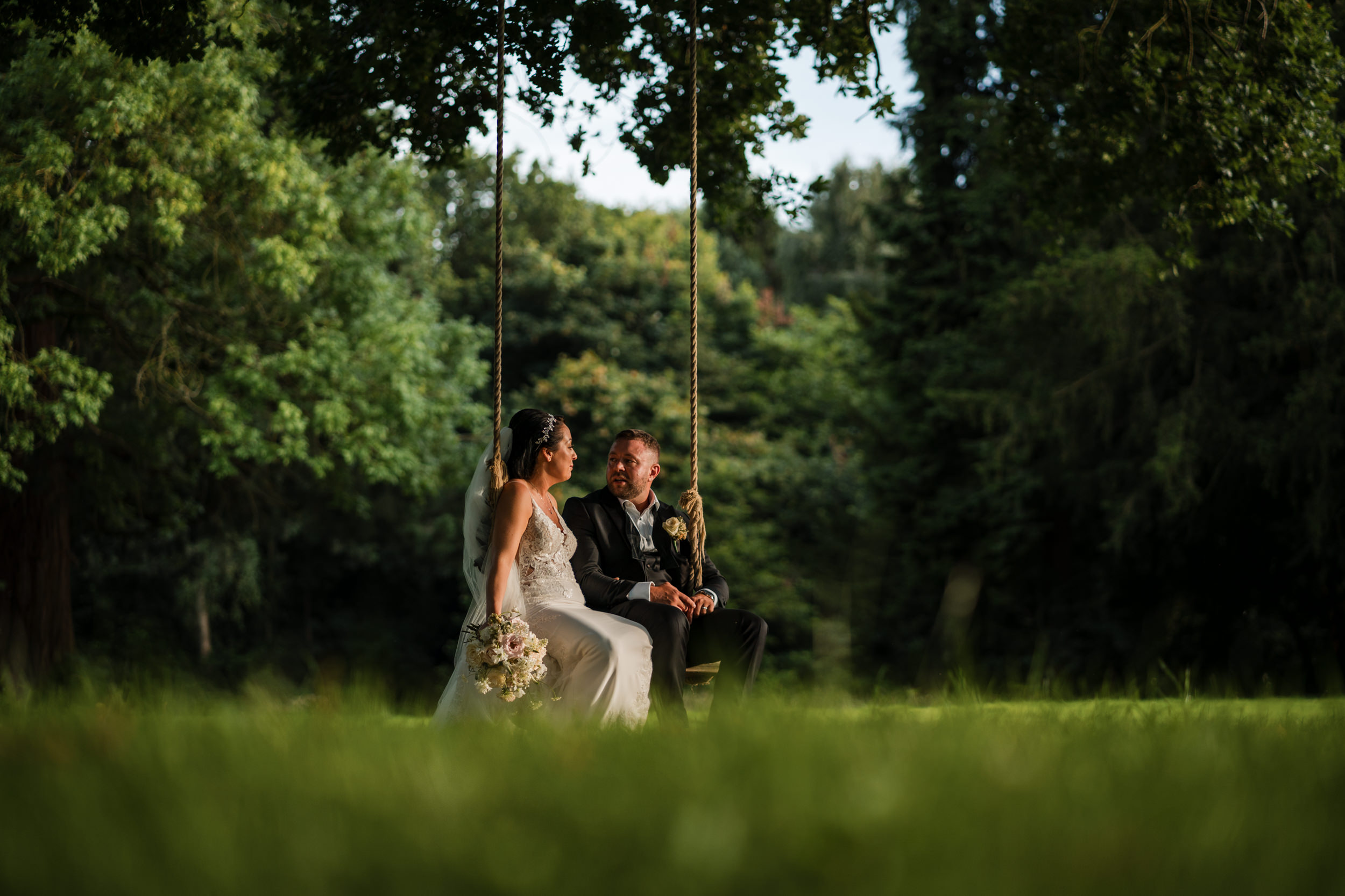 Bride and groom on the swing at Thicket Priory