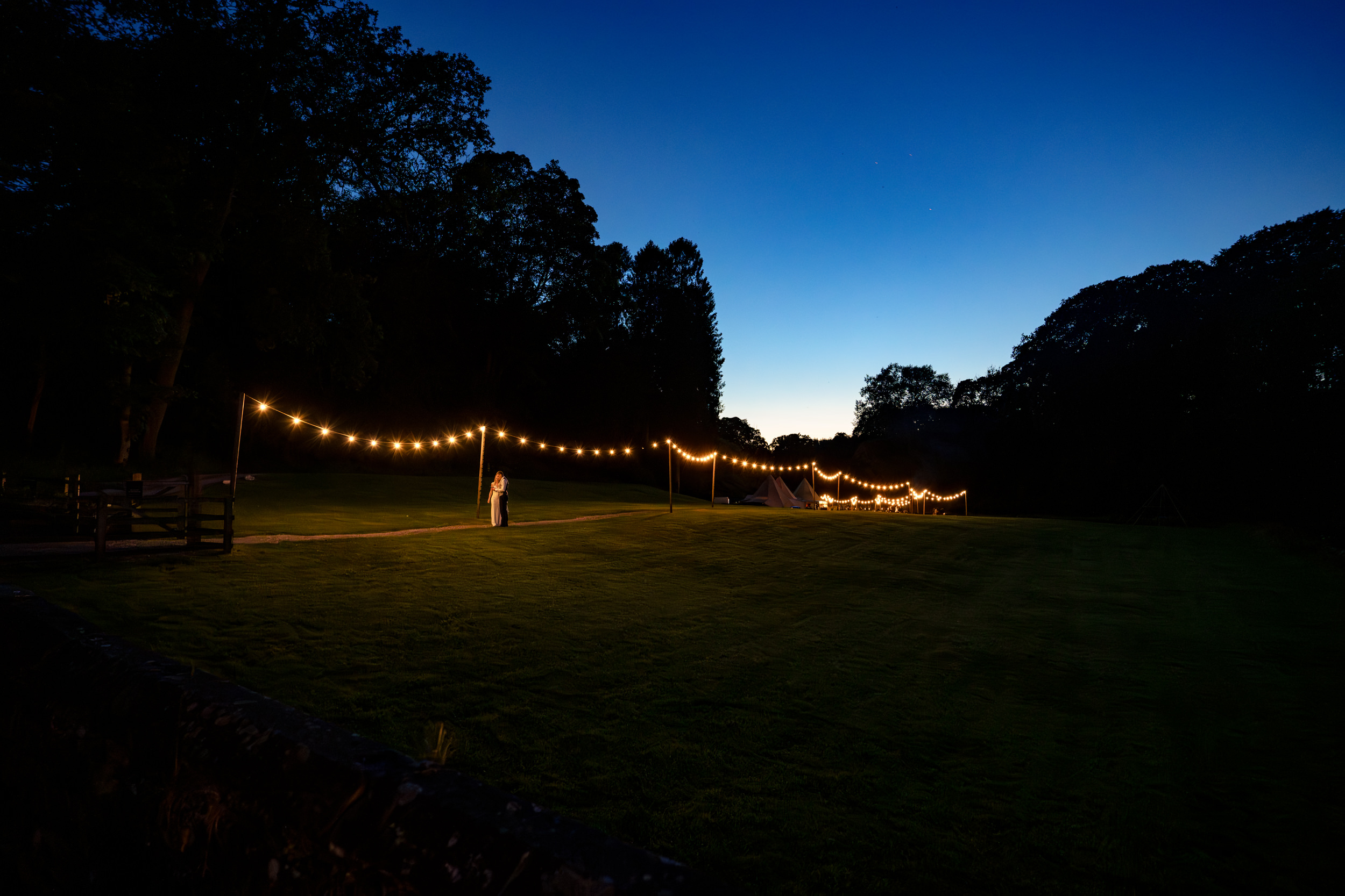 Bride and groom at night in Gisburne park