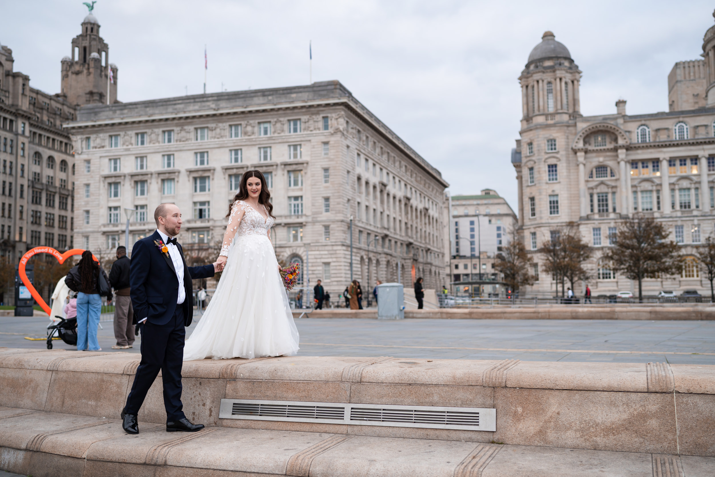 Couple walking together through the Albert Docks, Liverpool