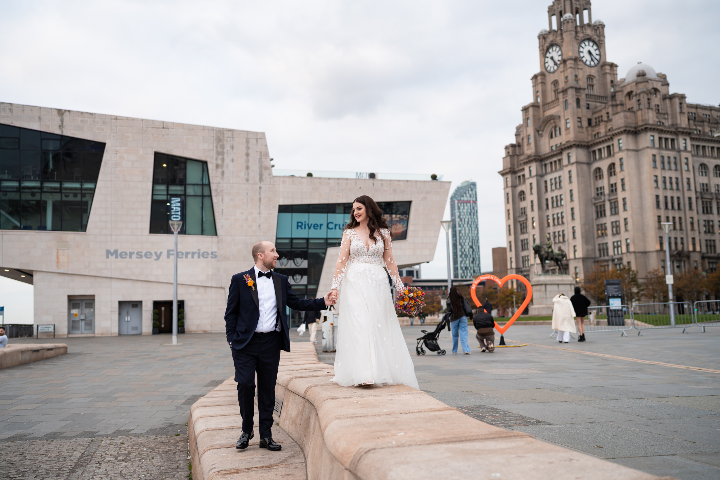 Couple walking together through the Albert Docks, Liverpool